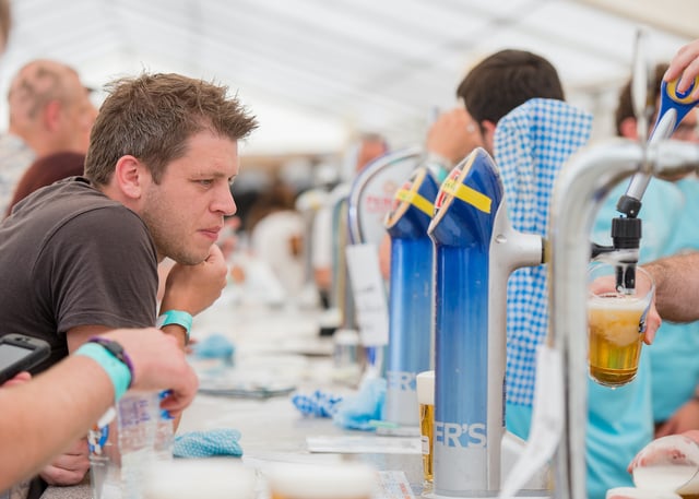 man waiting to be served beer