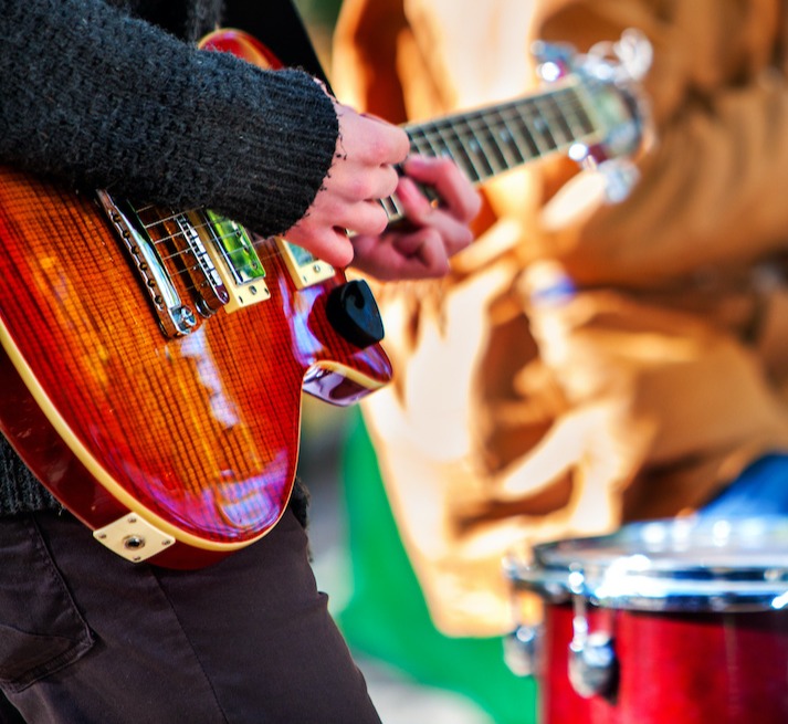 close up of band with guitar and drums cropped