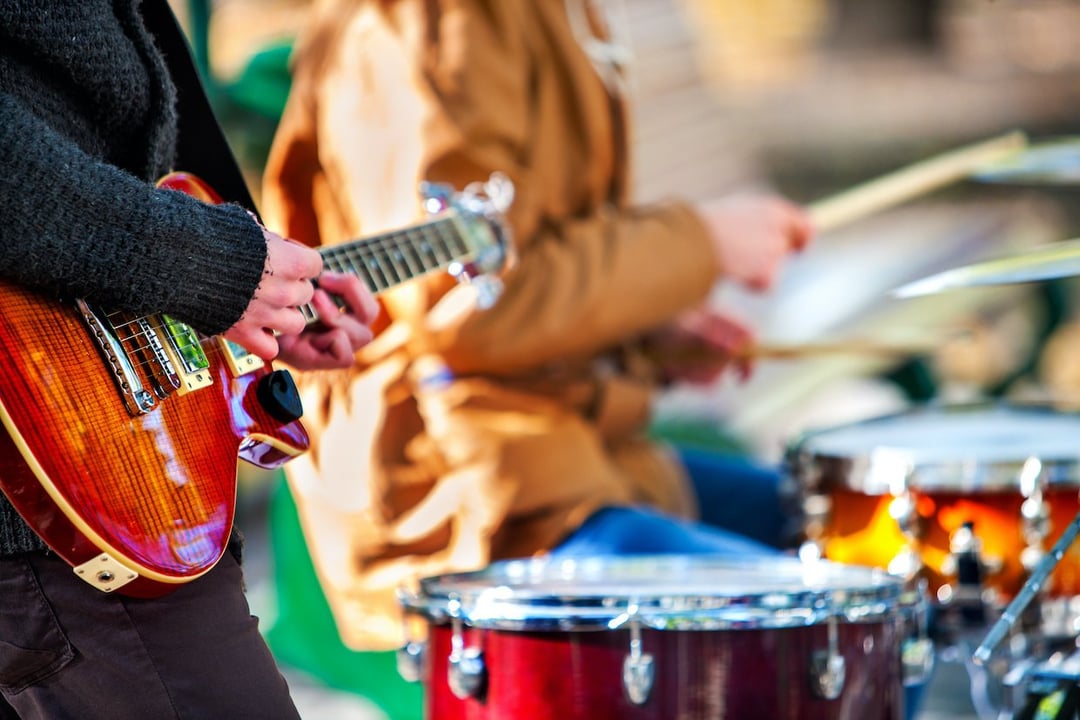 close up of band with guitar and drums